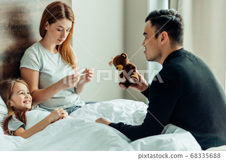 portrait of lovely family on bed at home portrait of lovely family on bed at home 68335688