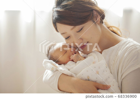 Mother holding a newborn baby Mother holding a newborn baby 68336900