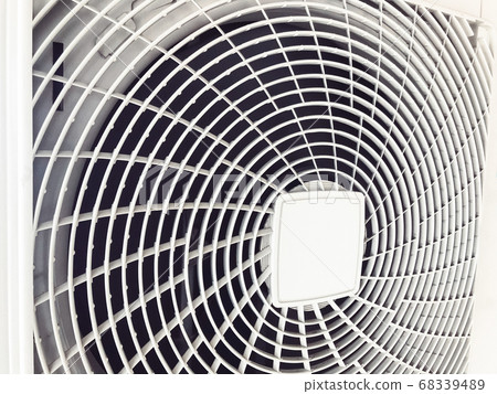 Compressor of air conditioner, the behinde of white machine that similar to the fan blades. There is a white sieve covered Compressor of air conditioner, the behinde of white machine that similar to the fan blades. There is a white sieve covered 68339489