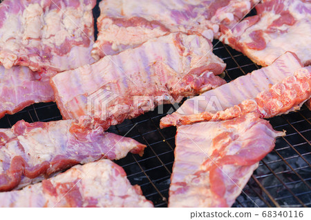 Grilled pork ribs on the grill or BBQ at street food market. Grilled pork ribs on the grill or BBQ at street food market. 68340116