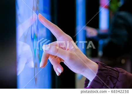 Woman using interactive touchscreen terminal with city map Woman using interactive touchscreen terminal with city map 68342238