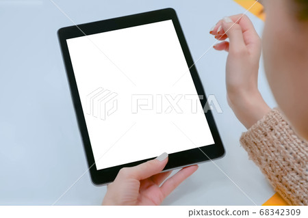Mockup image of digital tablet computer with white blank screen in woman hands 68342309