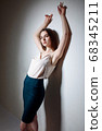 Sexy business woman standing near the wall 68345211