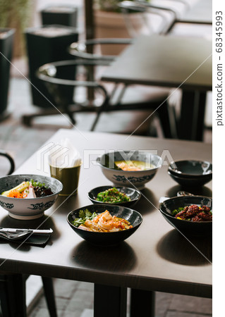 Dark table served with asian style japanese dishes Dark table served with asian style japanese dishes 68345993