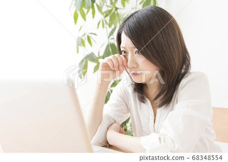 Female watching a movie on a laptop 68348554
