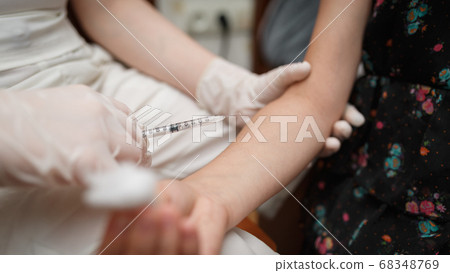 Vaccine injection into the hand of a little girl. Vaccine injection into the hand of a little girl. 68348769