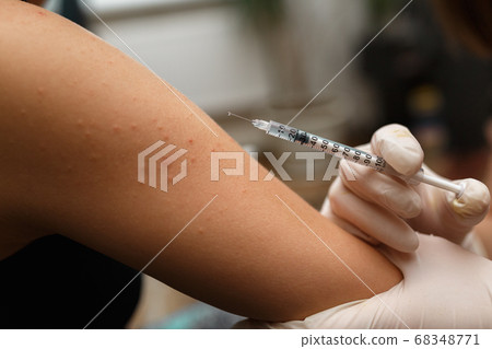 Pediatr vaccinating a little girl in her arm. Pediatr vaccinating a little girl in her arm. 68348771