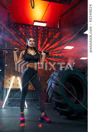 Female bodybuilder posing with sledgehammer. Female bodybuilder posing with sledgehammer. 68349024