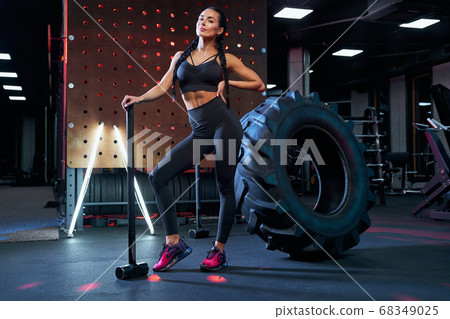 Stunning woman posing with sledgehammer. Stunning woman posing with sledgehammer. 68349025