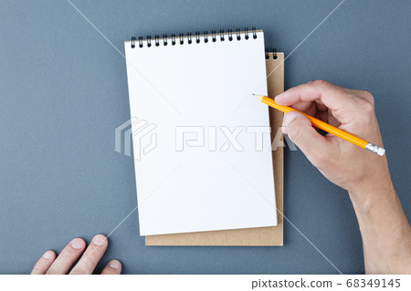 Notebook clear page and male hands with pencil. 68349145