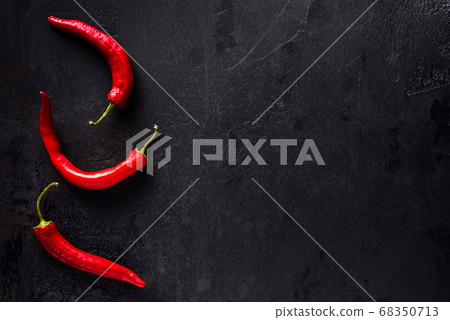 Red chilli peppers on black with copy space 68350713