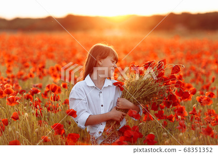Cute little girl in white dress with a bouquet of Cute little girl in white dress with a bouquet of 68351352
