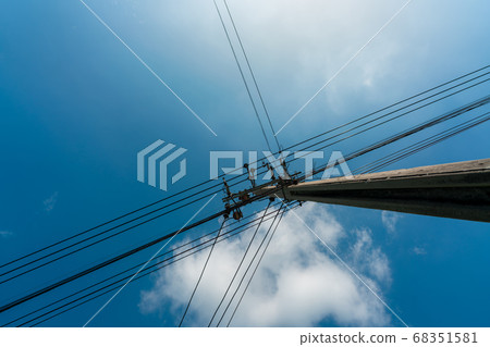 Looking up view of three-phase electric pylon. 68351581