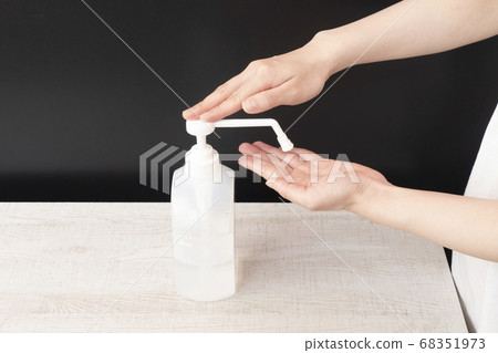 Women's hand to disinfect with alcohol Women's hand to disinfect with alcohol 68351973