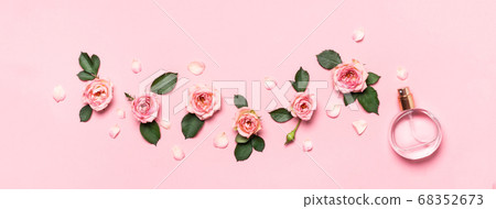 Women's perfume bottle and roses flowers buds and petals. Minimal beauty banner Women's perfume bottle and roses flowers buds and petals. Minimal beauty banner 68352673