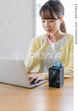 Young woman working remotely Young woman working remotely 68354855