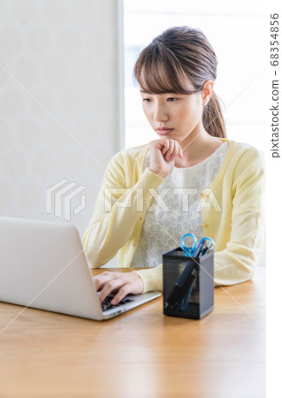 Young woman working remotely Young woman working remotely 68354856