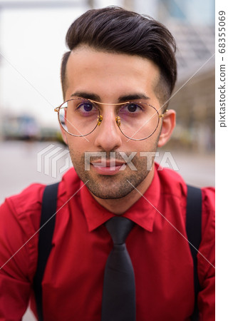 Young handsome Persian businessman exploring the city 68355069