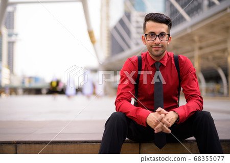 Young handsome Persian businessman exploring the city Young handsome Persian businessman exploring the city 68355077