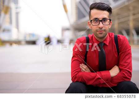 Young handsome Persian businessman exploring the city Young handsome Persian businessman exploring the city 68355078