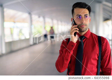 Young handsome Persian businessman exploring the city Young handsome Persian businessman exploring the city 68355098