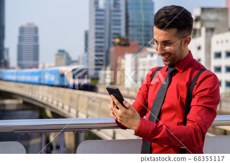 Young handsome Persian businessman exploring the city Young handsome Persian businessman exploring the city 68355117