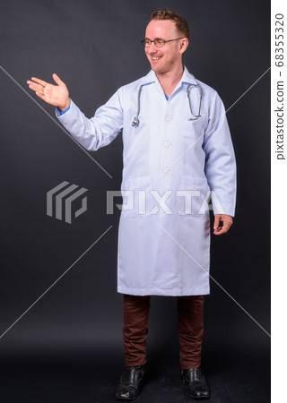 Portrait of happy handsome man doctor with blond hair 68355320