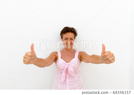 Mature beautiful tourist woman against white background Mature beautiful tourist woman against white background 68356157