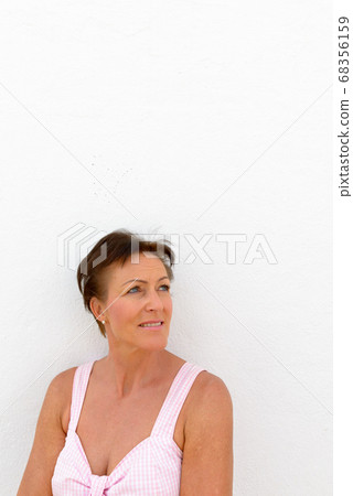 Mature beautiful tourist woman against white background Mature beautiful tourist woman against white background 68356159