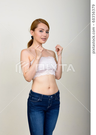 Portrait of happy young beautiful Asian woman in underwear as health concept 68356379