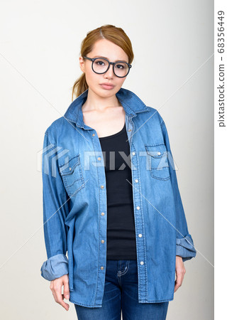 Portrait of young beautiful Asian woman with eyeglasses 68356449