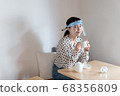 女人戴著口罩和喝茶 68356809