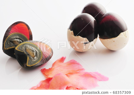 Preserved eggs and preserved ginger on white background Preserved eggs and preserved ginger on white background 68357309