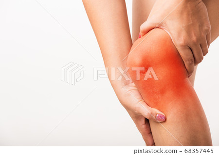 Woman holding her painful knee 68357445