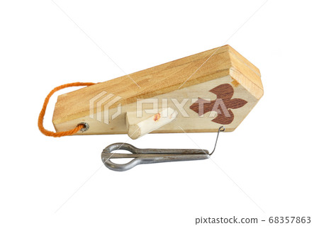 The Jew's harp. Musical instrument of the peoples of the North and Asia. Lip instrument of the peoples of the North and Asia. Isolated The Jew's harp. Musical instrument of the peoples of the North and Asia. Lip instrument of the peoples of the North and Asia. Isolated 68357863