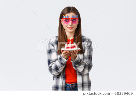 People lifestyle, holidays and celebration, emotions concept. Cute and silly birthday girl in funny glasses, look away think of wish as blowing lit candle on b-day cake, smiling excited People lifestyle, holidays and celebration, emotions concept. Cute and silly birthday girl in funny glasses, look away think of wish as blowing lit candle on b-day cake, smiling excited 68359469