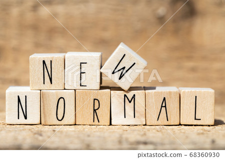 NEW NORMAL text on wooden cube. New normal life after covid-19 pandemic with social distancing and good hygiene on wooden background 68360930