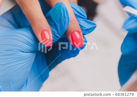 woman doing manicure in a beauty salon. Close-up of hands. 68361279