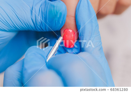 woman doing manicure in a beauty salon. Close-up of hands. 68361280