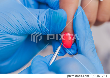 woman doing manicure in a beauty salon. Close-up of hands. 68361281