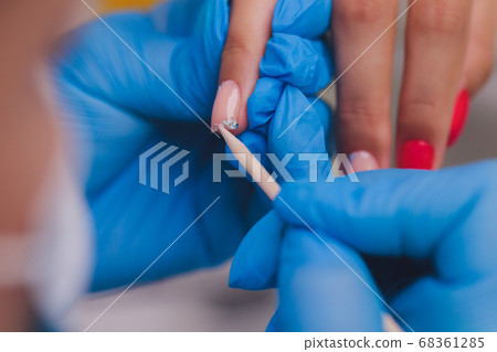 woman doing manicure in a beauty salon. Close-up of hands. 68361285