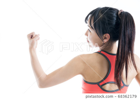 Young woman checking her muscles, muscle training, bicep, training, fitness Young woman checking her muscles, muscle training, bicep, training, fitness 68362179