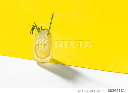 Glass ice lemonade with rosemary on yellow Glass ice lemonade with rosemary on yellow 68362181