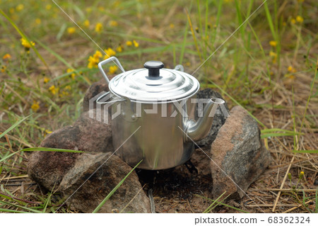 Tourist teapot on burner. 68362324