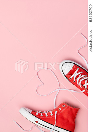 Minimal composition with red sneakers on pink 68362709