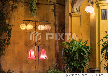 Shabby yellow wall, arch, lanterns and plant in pot) in the old town at night. Hoi An, Vietnam Shabby yellow wall, arch, lanterns and plant in pot) in the old town at night. Hoi An, Vietnam 68363242