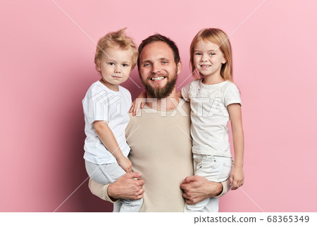 cheerful smiling daddy holding his kids in arms cheerful smiling daddy holding his kids in arms 68365349