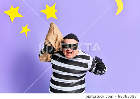 nervous man with a gun and sack looking at the camera with furious expression nervous man with a gun and sack looking at the camera with furious expression 68365588