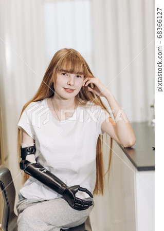 nice girl witout an arm posing to the camera 68366127