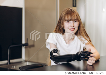 smiling awesome girl with artificial arm looking at the camera smiling awesome girl with artificial arm looking at the camera 68366128